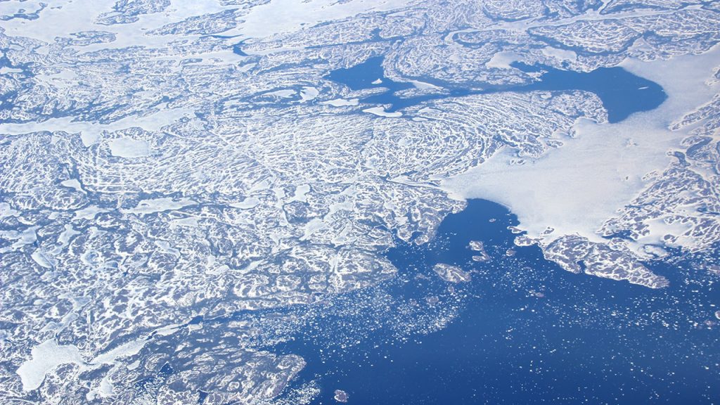Artic circle viewed from above, through a layer of semi-transparent clouds