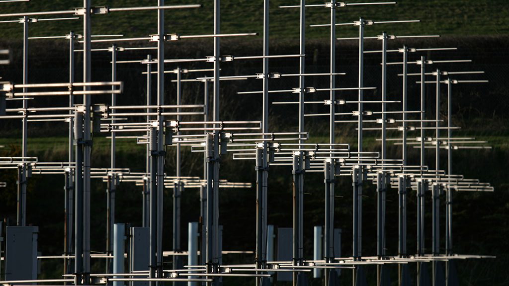 Around twenty silver metal antenna arranged in a line