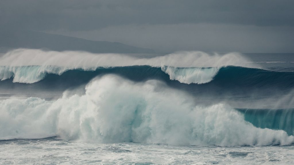 White waves crash towards the shoreline