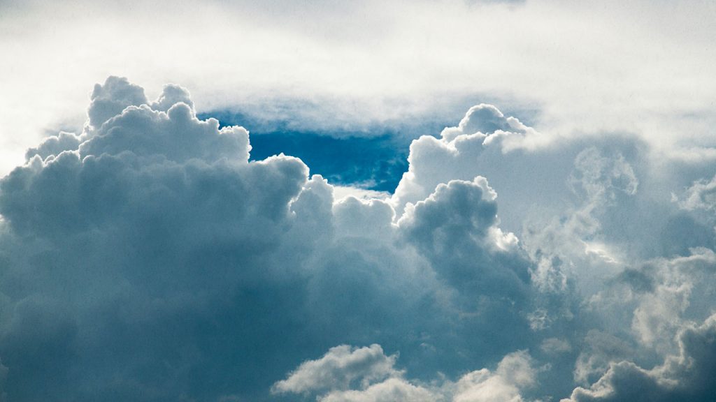 Fluffy, white clouds in a blue sky