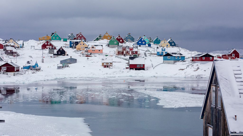 Brightly coloured houses, surrounded by snowy landscape in Greenland
