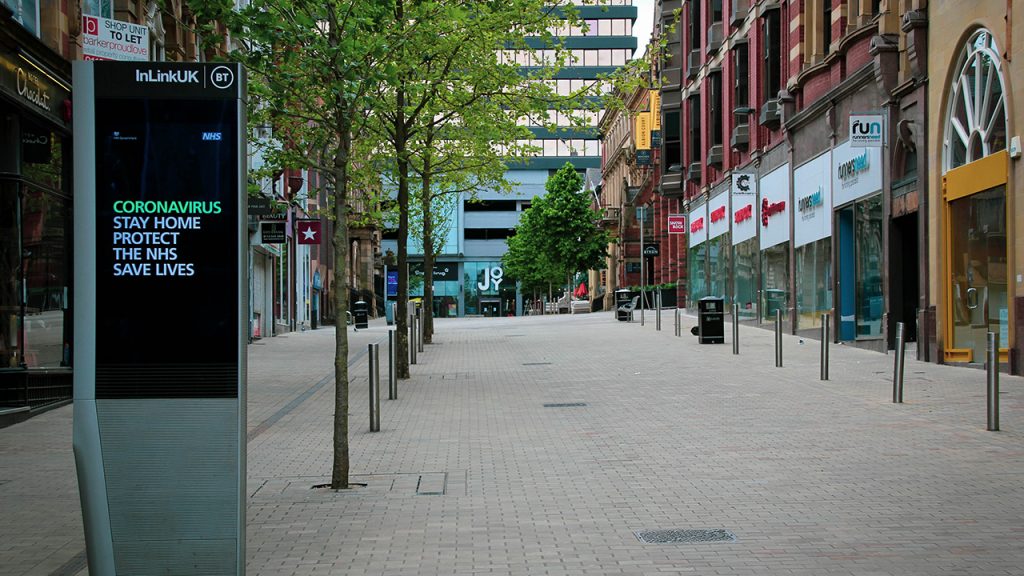 Empty pedestrianised high street, lined with shops.