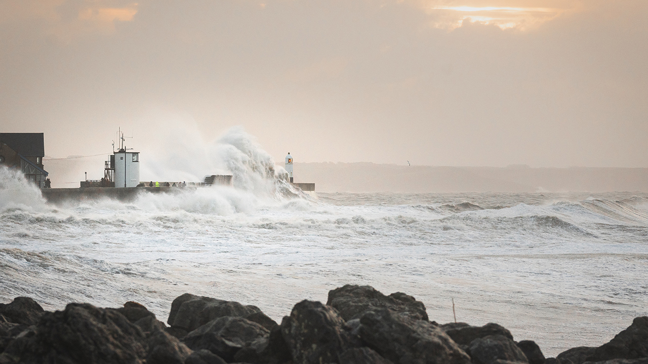 White waves crash against coastal peninsula