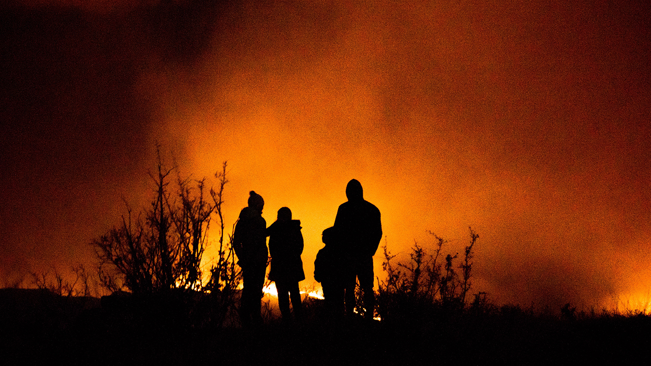 Family watch wildfires rage at night