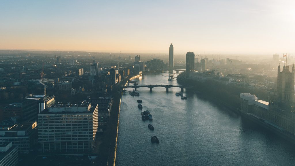 Hazy sky over a wide river and lots of tall buildings