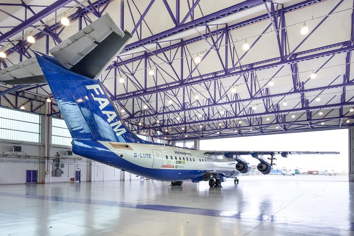 Blue and white aircraft with the word FAAM on the tail, inside an aircraft hangar