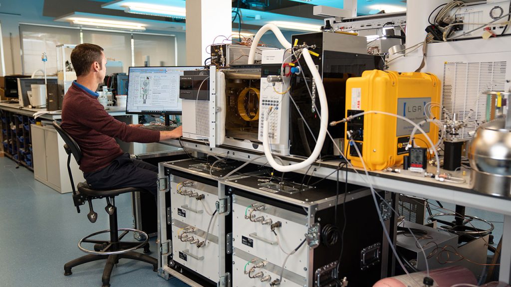 Person sits at computer desk in a laboratory