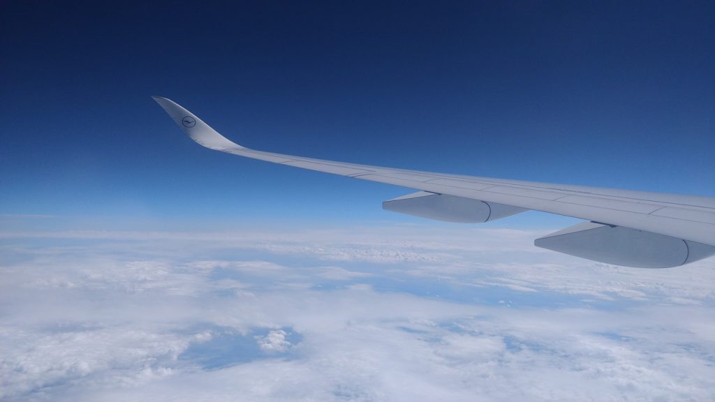 aircraft wing above clouds