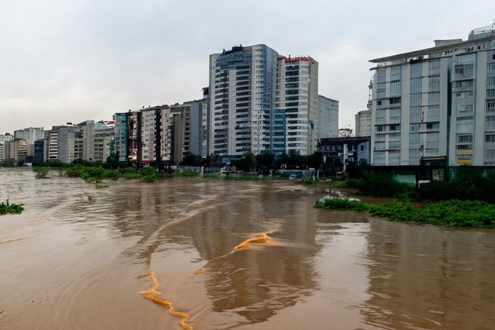 Flood waters surrounding blocks of flats.