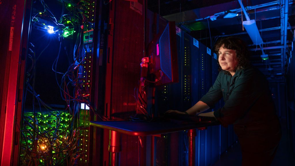 A scientist works on the JASMIN super computer.