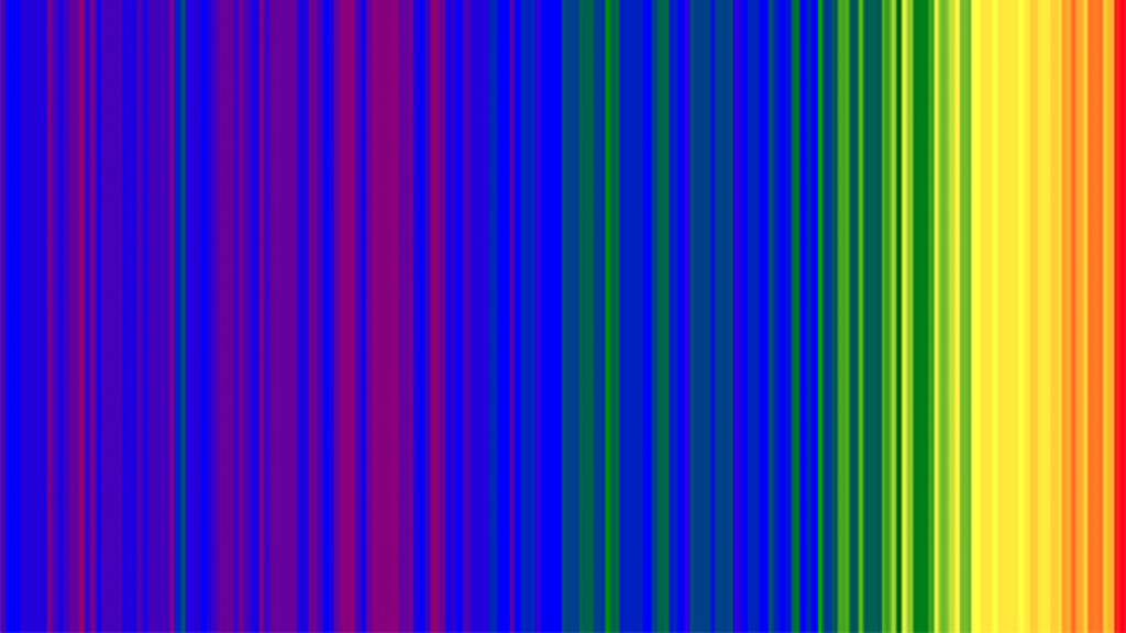 Vertical rainbow coloured stripes that show global average temperature change over the last 150 years. Blue and purple stripes on the left hand side show cooler years, and green, yellow, orange, red stripes to the right show warmer years.