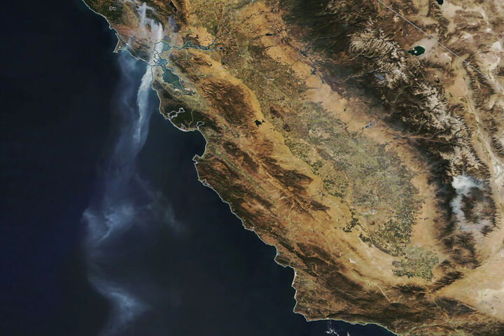 Satellite image of dry land and dark ocean.