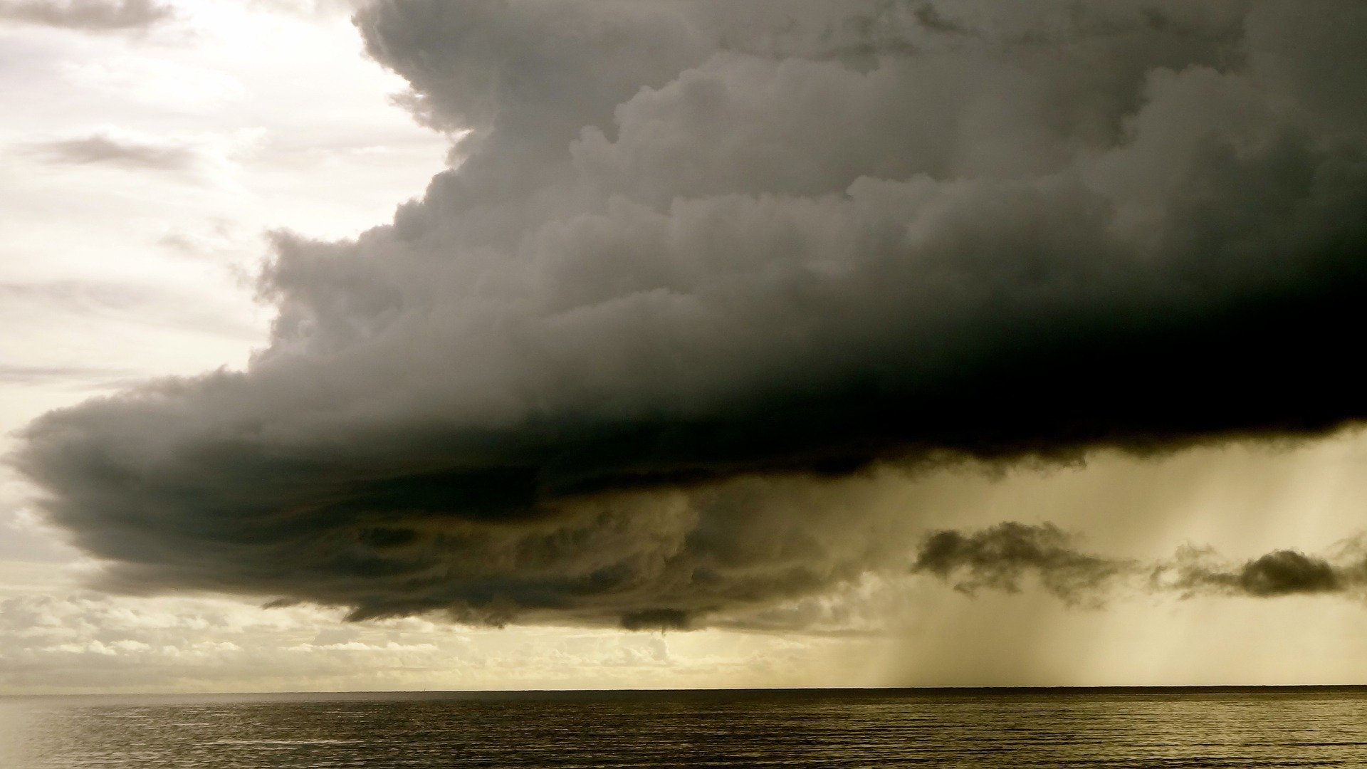 Dark grey storm cloud above the sea