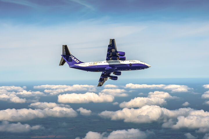 blue and white aircraft flying above small fluffy white clouds