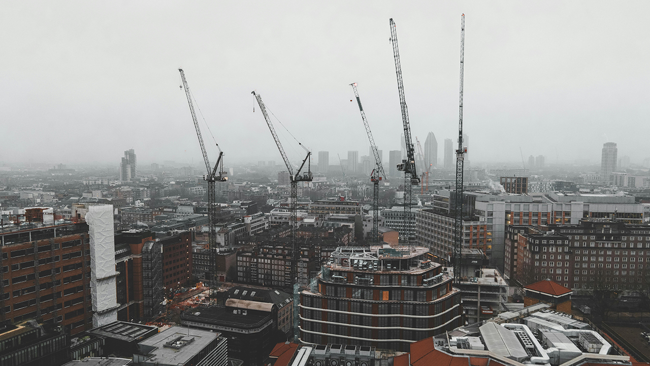 Foggy day in central London, with construction cranes and high rise buildings
