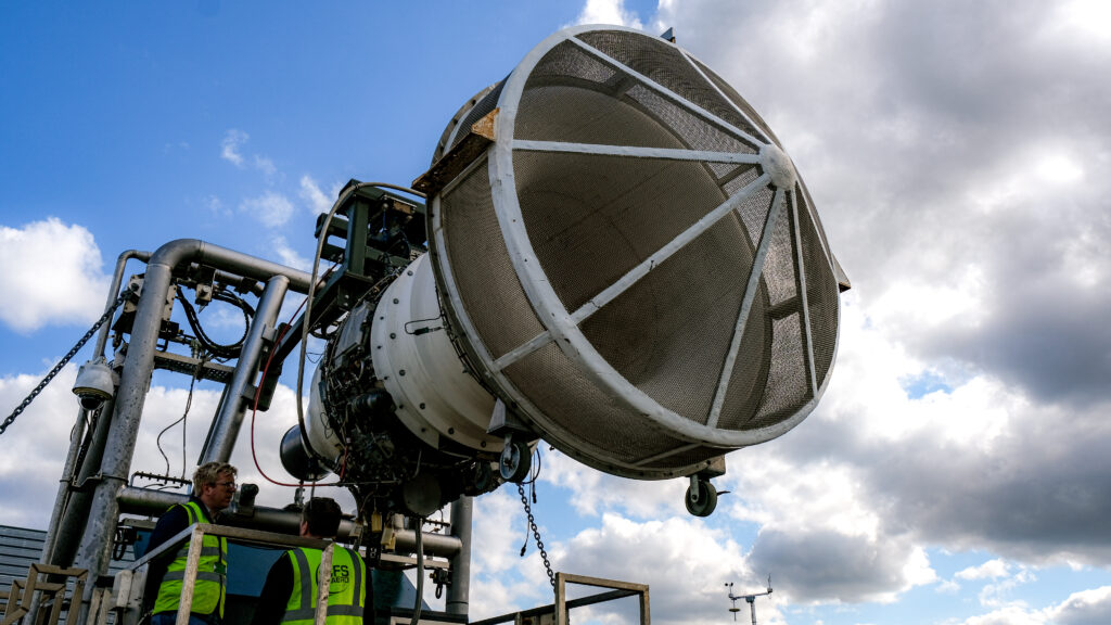 Aircraft engine mounted on a metal structure at an emissions testing facility