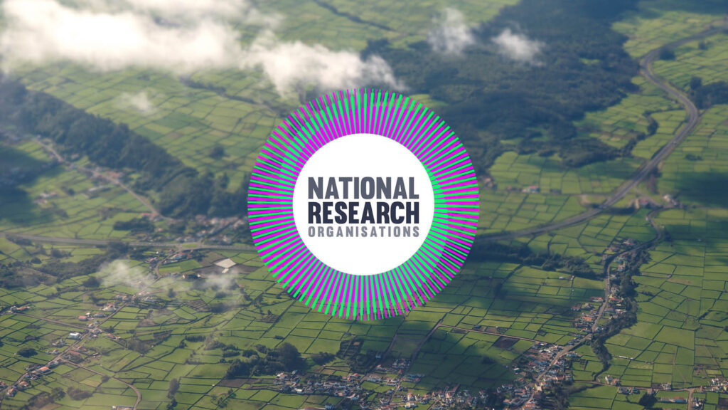 Aerial view of green fields and white clouds, with a purple and green logo that reads National Research Organisations.