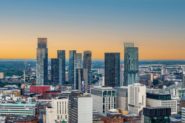 Glowing orange and blue sunrise sky in Manchester, with tall buildings