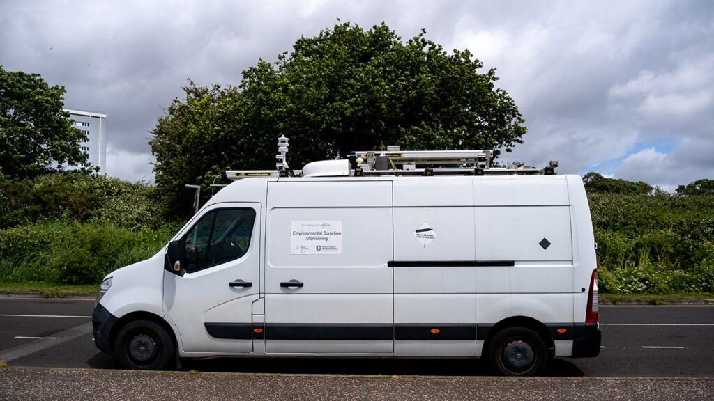 A large white van parked up on the side of a road.