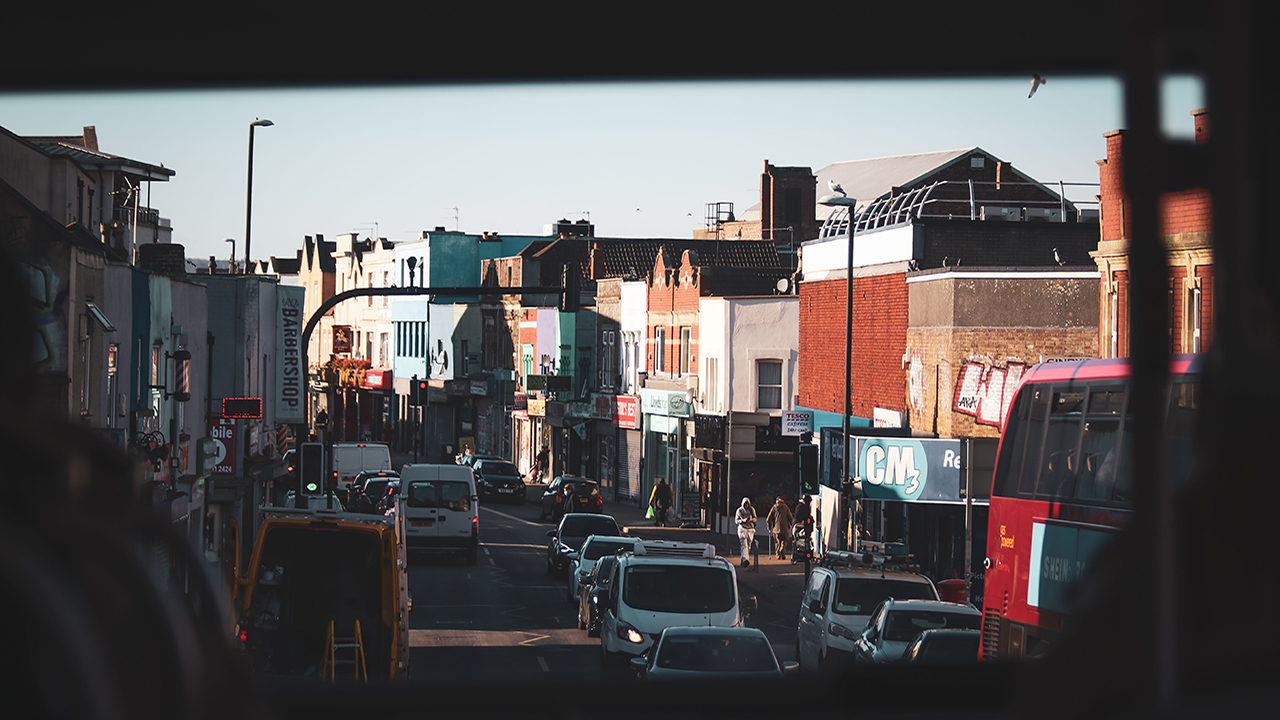View from inside a bus towards a busy street.