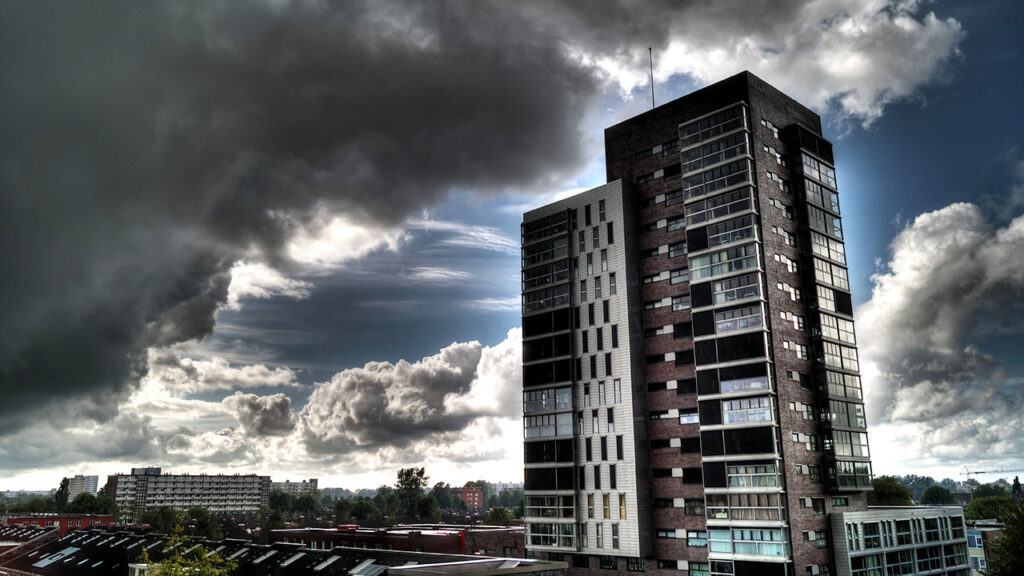 Storm clouds above a high rise tower of flats.
